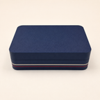 Closed navy clamshell peptide vial storage case with red and white stripe trim