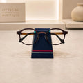 Simple Eyeglass Holder Stand front view — modern trapezoid silhouette in matte navy with red and white racing stripe